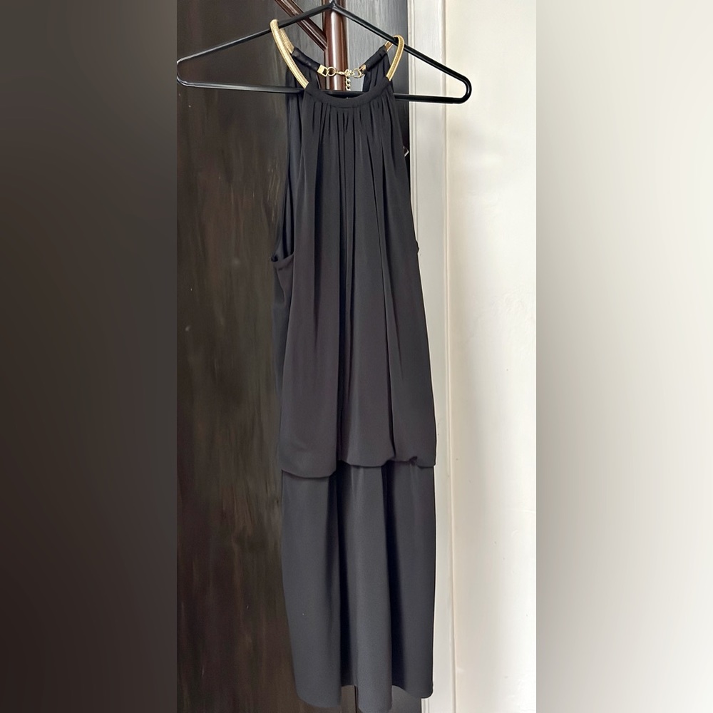 Black Jessica Simpson dress, ties with gold necklace around neck.